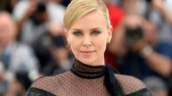 Elegant woman with blonde hair in glamorous attire at a public event, showcasing celebrity style and fashion.